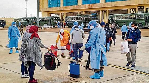 Indians evacuated from Iran undergo a disinfecting process before being quarantined at a Jaisalmer military facility in April.(PTI Photo)