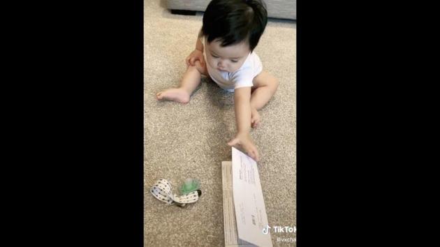 Carter picking up random items over his own toys.(TikTok/@ViChan)