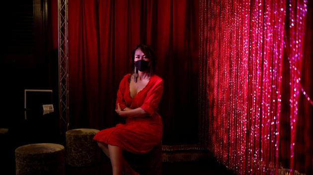 Burlesque show exotic dancer Aya Yumiko who performs under the name Aya Mermaid, poses in a bar where she used to perform and that is now closed, amid the coronavirus disease (COVID-19) outbreak, at Kabukicho nightlife district in Tokyo. (REUTERS)