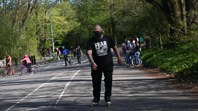 A man skates in Prospect Park. Residents of the Big Apple, which has been shut down since mid-March, are allowed outside to exercise providing they maintain six feet of distance and wear a mask when around others. (Yana Paskova / AFP) A man skates in Prospect Park. Residents of the Big Apple, which has been shut down since mid-March, are allowed outside to exercise providing they maintain six feet of distance and wear a mask when around others. (Yana Paskova / AFP)