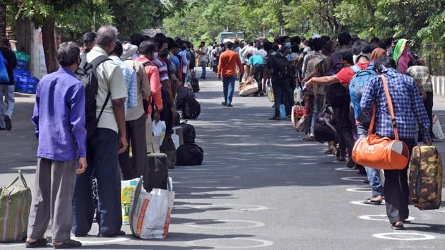 Migrant workers stand in queues to get checked by medical staff before boarding the buses to go to their native place during the Covid-19 lockdown in Surat on Tuesday. (ANI Photo) Migrant workers stand in queues to get checked by medical staff before boarding the buses to go to their native place during the Covid-19 lockdown in Surat on Tuesday. (ANI Photo)
