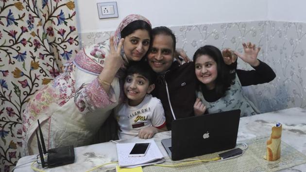 Associated Press photographer Mukhtar Khan celebrates with his family at his home in Srinagar, following the announcement that he was one of three AP photographers who won the Pulitzer Prize in Feature Photography. (Afnan Arif / AP)