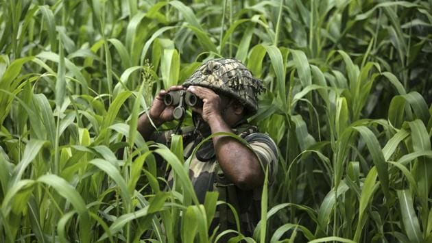 A Border Security Force (BSF) personnel keeps vigil near the India-Pakistan border at Garkhal in Akhnoor, about 35 kilometers west of Jammu, India on August 13, 2019. The image was part of a series of photographs by Associated Press photographers which won the 2020 Pulitzer Prize for Feature Photography. (Channi Anand / AP)