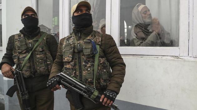 Security forces keep guard as a Kashmiri man prays on the occasion of Prophet Muhammad’s birth anniversary in Srinagar, India, November 10, 2019. Thousands of Kashmiri Muslims thronged the Hazratbal shrine, which houses a relic believed to be a hair from the beard of the Prophet. The image was part of a series of photographs by Associated Press photographers which won the 2020 Pulitzer Prize for Feature Photography. (Mukhtar Khan / AP)