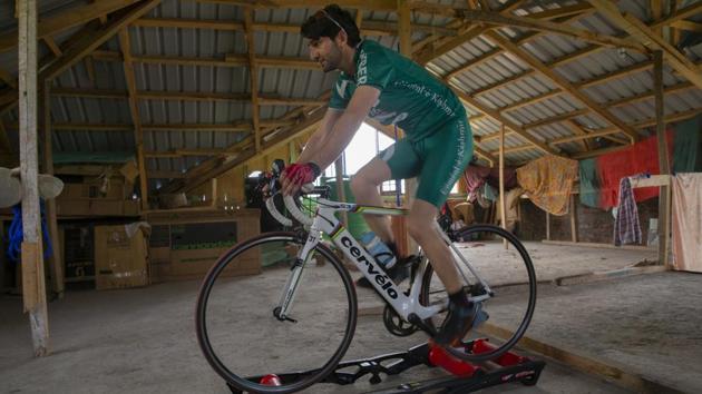 While the virus lockdown keeps people inside their homes, Umer Nabi has shifted his cycle to the attic his home in Burzahamahe, on the outskirts of Srinagar and replicates riding outdoors with the help of rollers. (Dar Yasin / AP)