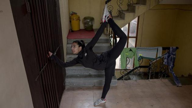 Under the coronavirus lockdown, Afreen Hyder is left with only one area where she can practice Taekwondo in the apartment she shares with her parents in Srinagar -- the apartment’s hallway. “I’ve ended up practicing in a place where I dislike doing it most,” Afreen said. But she keeps on going. (Dar Yasin / AP)