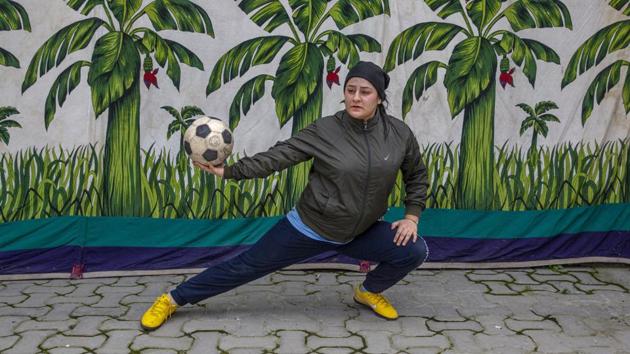 Kashmiri football coach Qudsiya Altaf poses for a photograph during practice inside a school compound that belongs to her father, near her home in Srinagar. Like many other athletes, the coronavirus pandemic has restricted Altaf to her neighbourhood. (Dar Yasin / AP)