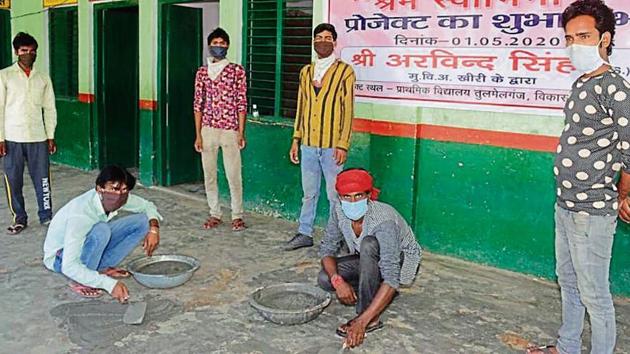 Migrants labourers engaged in repair works at a government-run primary school in Lakhimpur.(HT Photo) Migrants labourers engaged in repair works at a government-run primary school in Lakhimpur.(HT Photo)