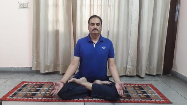 Dr Sanjeev Singh Rawat, senior yoga consultant at DMCH, performing a yoga asana at his home in Ludhiana on Wednesday. (HT Photo) Dr Sanjeev Singh Rawat, senior yoga consultant at DMCH, performing a yoga asana at his home in Ludhiana on Wednesday. (HT Photo)