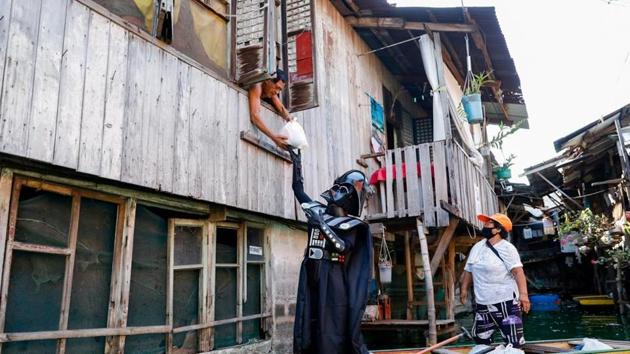 On May 4, also known as “Star Wars” Day and celebrated worldwide by fans of the franchise, government workers in costume also rode small wooden boats to distribute relief packs containing rice and canned goods in a nearby coastal neighbourhood.(Photo: Reuters/ Eloisa Lopez)