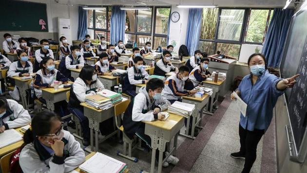High school senior students study in a classroom in Wuhan. Teenagers sat at individual desks spaced a metre (3.3 feet) apart, seeing their teachers in the flesh after months of distance learning. (AFP) High school senior students study in a classroom in Wuhan. Teenagers sat at individual desks spaced a metre (3.3 feet) apart, seeing their teachers in the flesh after months of distance learning. (AFP)