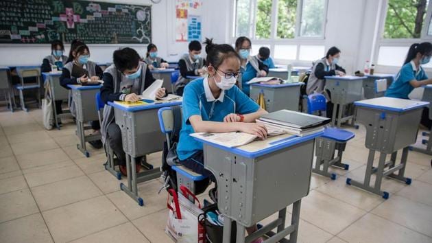 Senior students attend class at a high school in Wuhan in China's central Hubei province on May 6, 2020. - Senior school students returned to class on May 6 in the central Chinese city of Wuhan, where the coronavirus that has now swept the globe first emerged late last year. (AFP) Senior students attend class at a high school in Wuhan in China's central Hubei province on May 6, 2020. - Senior school students returned to class on May 6 in the central Chinese city of Wuhan, where the coronavirus that has now swept the globe first emerged late last year. (AFP)