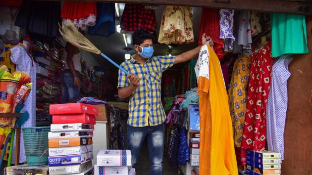 Nagaon: A shopkeeper arranges his garments shop that was opened after authorities eased restrictions amid ongoing COVID-19 lockdown, in Nagaon district of Assam on Tuesday.(PTI File Photo)