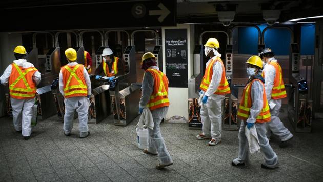 Workers clean Grand Central station in New York City on May 5. Fewer trains had been running in the overnight hours anyway, but the shutdown allows for daily cleanings and for city workers to move homeless people who have been more visible in subway cars during the coronavirus, according to an AP report. (Eduardo Munoz Alvarez / Getty Images /AFP)