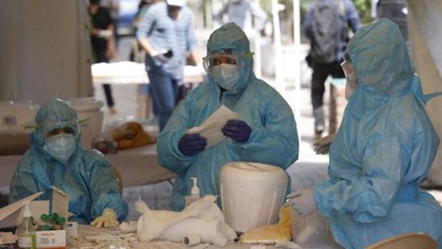 Health workers at a Covid-19 testing centre in New Delhi. (AP File Photo) Health workers at a Covid-19 testing centre in New Delhi. (AP File Photo)