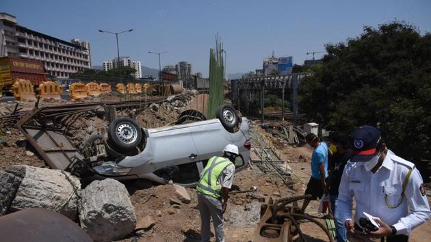 The car which fell off Kopri bridge in Thane on Thursday. (Praful Gangurde/HT photo) The car which fell off Kopri bridge in Thane on Thursday. (Praful Gangurde/HT photo)