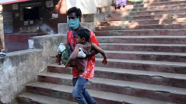 A father rushes to take his child for treatment at King George Hospital after the gas leakage. Visuals on social media showed parents carrying unconscious children in their arms while running to get medical help. People were seen dazed sitting on the pavements. (PTI) A father rushes to take his child for treatment at King George Hospital after the gas leakage. Visuals on social media showed parents carrying unconscious children in their arms while running to get medical help. People were seen dazed sitting on the pavements. (PTI)