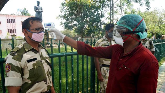 A medic checks the temperature of SSB constable during the Covid-19 lockdown, in Bhubaneswar on Saturday. (ANI Photo) A medic checks the temperature of SSB constable during the Covid-19 lockdown, in Bhubaneswar on Saturday. (ANI Photo)