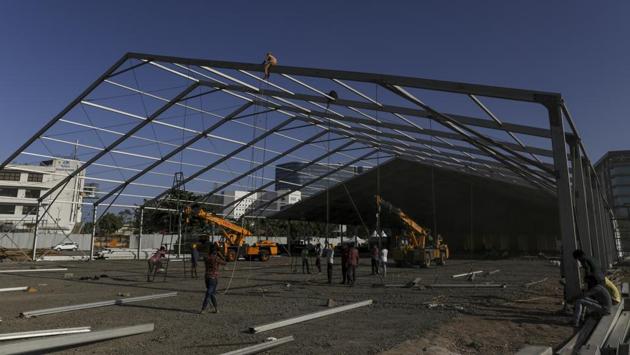 Workers prepare a metal frame during the construction of a 1,000 bed non-critical hospital for Covid-19 treatment at the Bandra Kurla Complex exhibition ground in Mumbai, on May 6, 2020. The hospital is expected to be up and running within a fortnight. (Dhiraj Singh / Bloomberg) Workers prepare a metal frame during the construction of a 1,000 bed non-critical hospital for Covid-19 treatment at the Bandra Kurla Complex exhibition ground in Mumbai, on May 6, 2020. The hospital is expected to be up and running within a fortnight. (Dhiraj Singh / Bloomberg)