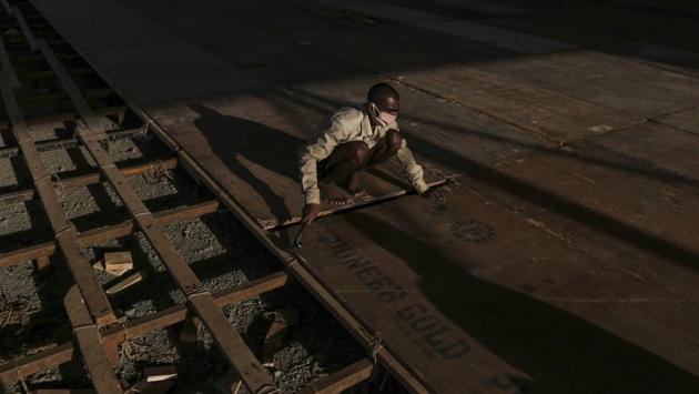 A worker lays flooring panels in the facility. Non-critical corona care centres such as this one will help monitor asymptomatic cases, acting as locations for quarantine and isolation. (Dhiraj Singh / Bloomberg) A worker lays flooring panels in the facility. Non-critical corona care centres such as this one will help monitor asymptomatic cases, acting as locations for quarantine and isolation. (Dhiraj Singh / Bloomberg)
