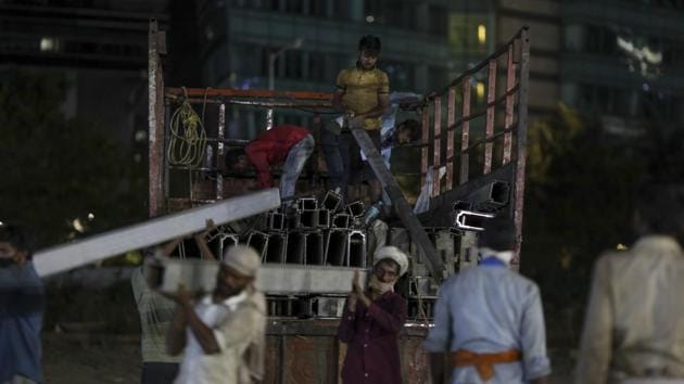 Workers unload metal bracing from a truck at the exhibition grounds in Bandra Kurla Complex. The Mumbai Metropolitan Region (MMR), which includes the city and its neighbouring areas, accounts for 25% of the total cases in India as of Wednesday. (Dhiraj Singh / Bloomberg) Workers unload metal bracing from a truck at the exhibition grounds in Bandra Kurla Complex. The Mumbai Metropolitan Region (MMR), which includes the city and its neighbouring areas, accounts for 25% of the total cases in India as of Wednesday. (Dhiraj Singh / Bloomberg)