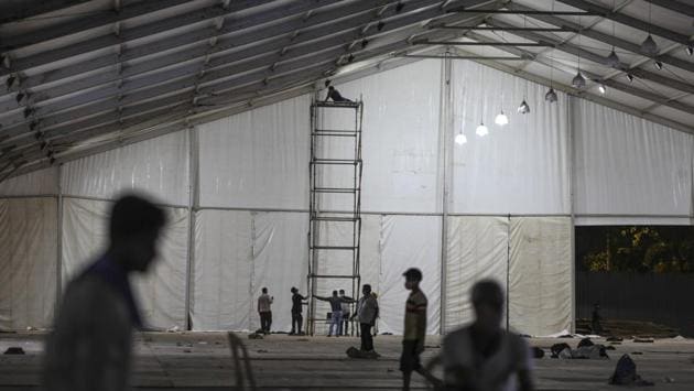 Workers labour on a scaffolding tower during the construction of a non-critical hospital for Covid-19 treatment. The BMC has maintained that it expects around 75,000 coronavirus cases by the end of the month according to its projections for the city. (Dhiraj Singh / Bloomberg) Workers labour on a scaffolding tower during the construction of a non-critical hospital for Covid-19 treatment. The BMC has maintained that it expects around 75,000 coronavirus cases by the end of the month according to its projections for the city. (Dhiraj Singh / Bloomberg)