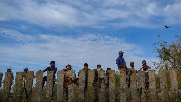 People look on from behind a stone fence with barbed wires, at Ashram. The first cluster of infections from a hospital was reported at the Delhi State Cancer Institute in the first week of April – 26 health care workers, four cancer patients and a two-year-old child were among those who tested positive. Following which several clusters of infections have been reported from hospitals. (Amal KS / HT Photo) People look on from behind a stone fence with barbed wires, at Ashram. The first cluster of infections from a hospital was reported at the Delhi State Cancer Institute in the first week of April – 26 health care workers, four cancer patients and a two-year-old child were among those who tested positive. Following which several clusters of infections have been reported from hospitals. (Amal KS / HT Photo)
