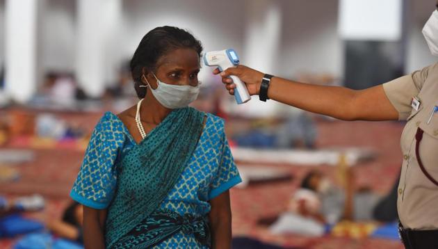 A woman undergoes thermal screening Migrant workers at Yamuna Sports Complex turned into shelter home during lockdown, in New Delhi. (Raj K Raj/HT Photo) A woman undergoes thermal screening Migrant workers at Yamuna Sports Complex turned into shelter home during lockdown, in New Delhi. (Raj K Raj/HT Photo)