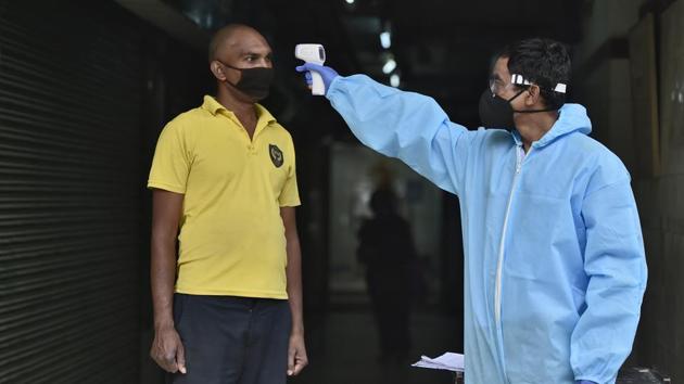 A visitor undergoes thermal screening at the entrance of an office building in Nehru Place. About 1,500 cases have been added to the Delhi tally in the last five days. The capital accounts for 10.3% of the total cases in the country. (Burhaan Kinu / HT Photo) A visitor undergoes thermal screening at the entrance of an office building in Nehru Place. About 1,500 cases have been added to the Delhi tally in the last five days. The capital accounts for 10.3% of the total cases in the country. (Burhaan Kinu / HT Photo)