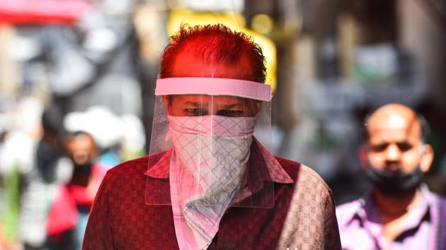 A man seen covering his face with face shield as a precautionary measure from coronavirus at Azadpur Mandi, in New Delhi, India, on Thursday, May 7, 2020.(Sanchit Khanna/HT PHOTO)