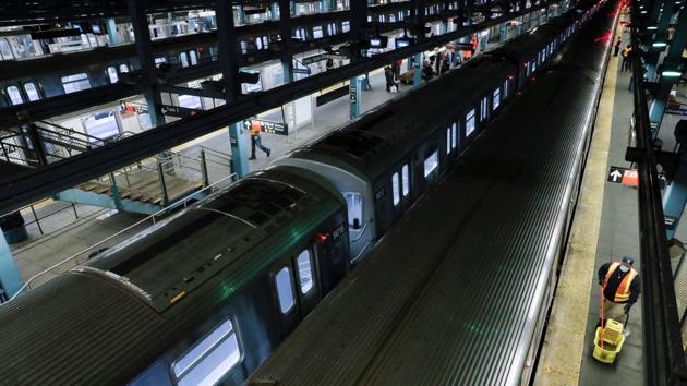 A cleaner walks on the platform near rows of stationary trains as the MTA Subway closed overnight for cleaning and disinfecting during the outbreak of the coronavirus disease (Covid-19) in the Brooklyn borough of New York City, US. (REUTERS)