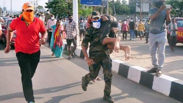 A security personnel carries a man on his shoulders in an area affected by the gas leak. According to news agency ANI, National Disaster Response Force (NDRF) chief SN Pradhan said that about 1,000 to 1,500 people had been evacuated by the authorities and more than 800 taken to hospital. (ANI) A security personnel carries a man on his shoulders in an area affected by the gas leak. According to news agency ANI, National Disaster Response Force (NDRF) chief SN Pradhan said that about 1,000 to 1,500 people had been evacuated by the authorities and more than 800 taken to hospital. (ANI)