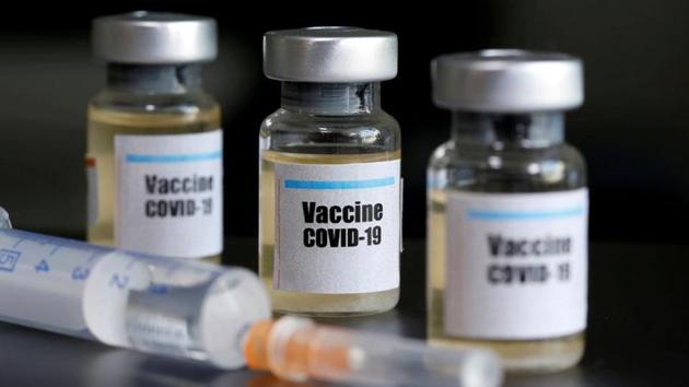 Small bottles labelled with a "Vaccine Covid-19" sticker and a medical syringe.(Reuters File Photo)