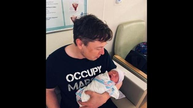 The image shows Elon Musk holding is newborn son.(Twitter/Elon Musk)