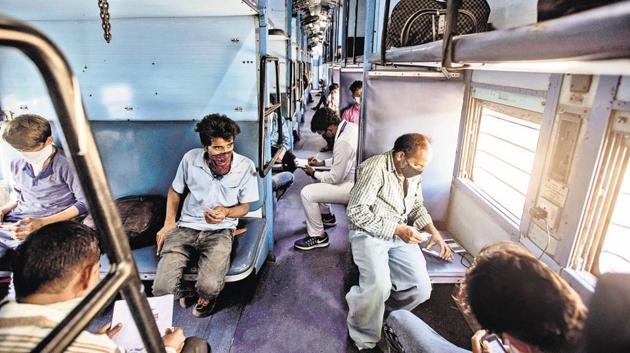 Migrant labourers inside the special train at Uruli railway station on Thursday. The train was arranged to send 1,093 labourers to Madhya Pradesh. (Pratham Gokhale/HT Photo) Migrant labourers inside the special train at Uruli railway station on Thursday. The train was arranged to send 1,093 labourers to Madhya Pradesh. (Pratham Gokhale/HT Photo)