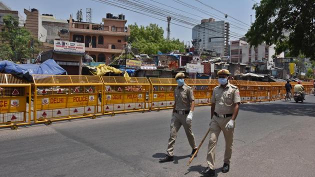 Delhi Civil defence personnel wearing a face mask as they patrol in JJ colony, one of the containment zones, during lockdown to curb the spread of coronavirus in New Delhi. (Raj K Raj/HT PHOTO)