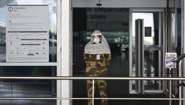 A CISF personnel wearing a face shield seen ahead of the arrival of Indians evacuees from Singapore and Dhaka, in IGI airport, New Delhi. In the first week of the massive operation, 64 flights will bring 15,000 Indian citizens home from 12 countries. (Vipin Kumar / HT Photo) A CISF personnel wearing a face shield seen ahead of the arrival of Indians evacuees from Singapore and Dhaka, in IGI airport, New Delhi. In the first week of the massive operation, 64 flights will bring 15,000 Indian citizens home from 12 countries. (Vipin Kumar / HT Photo)
