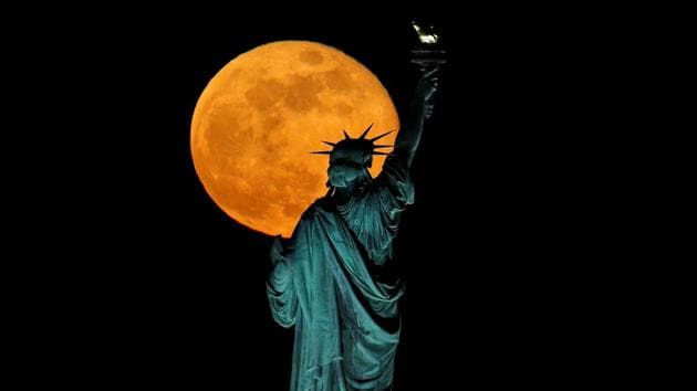 The full moon, also known as the Supermoon or Flower Moon, rises above the Statue of Liberty, as seen from Jersey City, New Jersey, U.S., May 7, 2020. REUTERS/Brendan McDermid TPX IMAGES OF THE DAY(REUTERS)