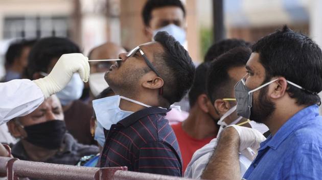 Medics collect swab samples of staff and students of Guwahati Medical College and Hospital for Covid-19 test(PTI Photo) Medics collect swab samples of staff and students of Guwahati Medical College and Hospital for Covid-19 test(PTI Photo)