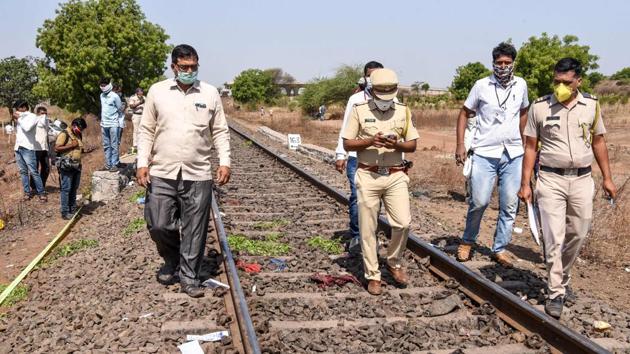 Police personnel along with officials walk on a rail track as they check the site following a train accident in Maharashtra, on Friday. (AFP Photo) Police personnel along with officials walk on a rail track as they check the site following a train accident in Maharashtra, on Friday. (AFP Photo)