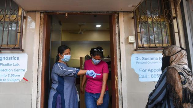 A staff directs patients as they queue outside a doctor's clinic to get medical certificates during lockdown. Maharashtra has so far tested 1,90,879 samples, of which 1,73,838 have tested negative. State health minister Rajesh Tope said that they are testing around 8,000 to 10,000 samples everyday. (INDRANIL MUKHERJEE / AFP) A staff directs patients as they queue outside a doctor's clinic to get medical certificates during lockdown. Maharashtra has so far tested 1,90,879 samples, of which 1,73,838 have tested negative. State health minister Rajesh Tope said that they are testing around 8,000 to 10,000 samples everyday. (INDRANIL MUKHERJEE / AFP)