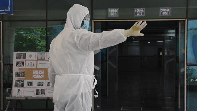 A hospital staff with PPE in front of entrance of a special coronavirus clinic at The Medical College and Hospital during lockdown, in Kolkata on Thursday. (Samir Jana/HT Photo) A hospital staff with PPE in front of entrance of a special coronavirus clinic at The Medical College and Hospital during lockdown, in Kolkata on Thursday. (Samir Jana/HT Photo)