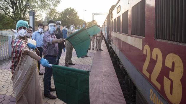 Naval Kishore Ram (2nd from left), District Collector waves flag for special train at Uruli railway station in Pune.(Pratham Gokhale/HT Photo)