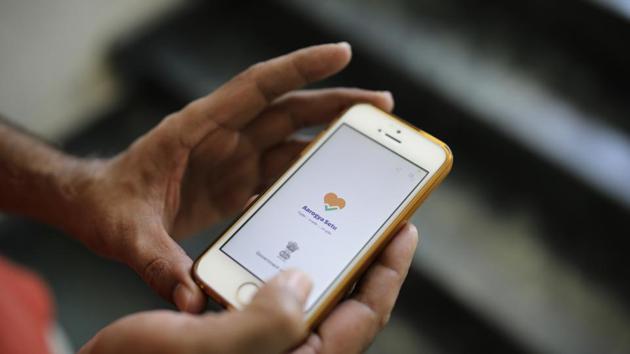 In this Thursday, May 7, 2020 photo, an Indian man uses Aarogya Setu app on his mobile phone in New Delhi, India. As India enters an extended coronavirus lockdown, the government is fervently pursuing contact tracing to control infections. At the heart of the effort in the country of 1.3 billion people is a smartphone app that evaluates users’ infection risk based on location services such as Bluetooth and GPS. (AP Photo/Altaf Qadri) (AP) In this Thursday, May 7, 2020 photo, an Indian man uses Aarogya Setu app on his mobile phone in New Delhi, India. As India enters an extended coronavirus lockdown, the government is fervently pursuing contact tracing to control infections. At the heart of the effort in the country of 1.3 billion people is a smartphone app that evaluates users’ infection risk based on location services such as Bluetooth and GPS. (AP Photo/Altaf Qadri) (AP)