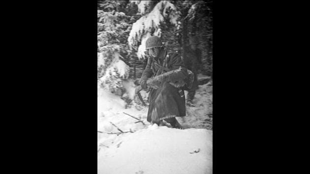 In this 1944 photo titled "Hell In Hurtgen,” Vaccaro shows an American soldier in Germany's Hurtgen Forest. Vaccaro attributes his longevity to “blind luck, red wine” and determination. “To me, the greatest thing that you can do is challenge the world,” he told AP. (Tony Vaccaro via AP)