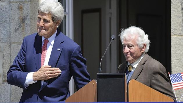 In this Saturday, June 7, 2014 file photo, US Secretary of State John Kerry and World War II photographer Tony Vaccaro, right, attend the inauguration of the Tony Vaccaro Square, in front of the Saint-Briac-sur-Mer city hall, western France. (Jean Sebastien Evrard / AP)