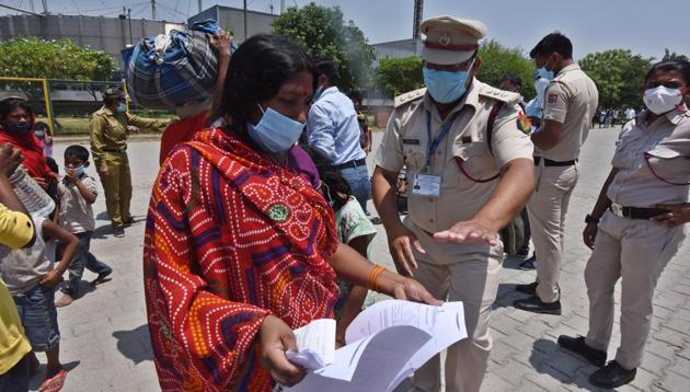 Migrant workers in New Delhi have their documents checked at Yamuna Sports Complex before they board a transit bus which will ferry them to a Shramik Special train headed for Bihar on Friday. (Raj K Raj/HT PHOTO) Migrant workers in New Delhi have their documents checked at Yamuna Sports Complex before they board a transit bus which will ferry them to a Shramik Special train headed for Bihar on Friday. (Raj K Raj/HT PHOTO)