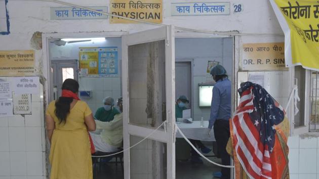 People waiting for a consultation with a doctor at MMG Hospital in Ghaziabad.(Sakib Ali /Hindustan Times)