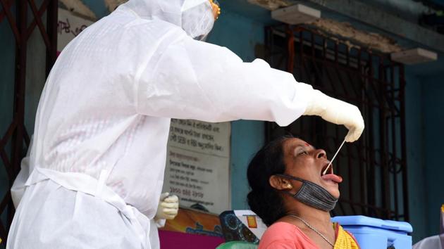 Medic collects swab sample form women for Covid-19 testing at 13 Gouribari in Kolkata on Friday.(ANI File Photo) Medic collects swab sample form women for Covid-19 testing at 13 Gouribari in Kolkata on Friday.(ANI File Photo)