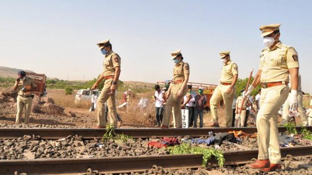 Police personnel inspect the spot after a goods train ran over a group of migrant workers while they were sleeping on the tracks in Aurangabad district on Friday. (PTI) Police personnel inspect the spot after a goods train ran over a group of migrant workers while they were sleeping on the tracks in Aurangabad district on Friday. (PTI)